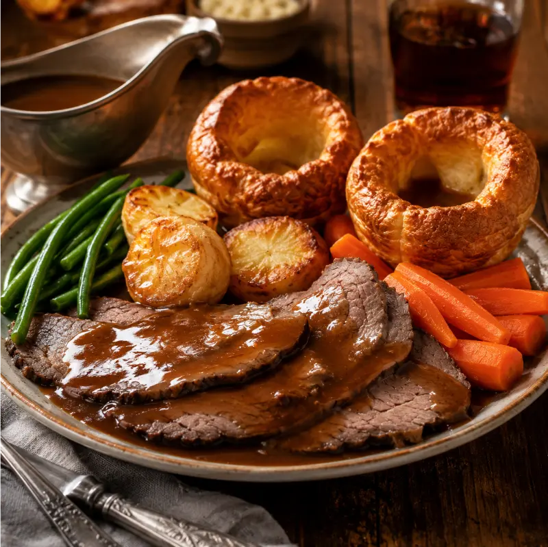 Traditional Yorkshire puddings served with roast beef and rich gravy